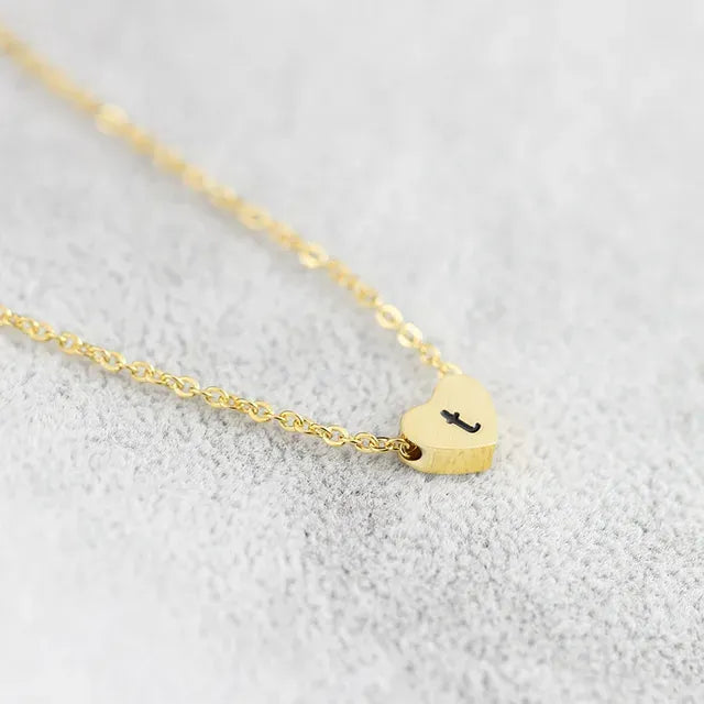 Gold necklace with a heart-shaped pendant on a light gray background - Affordbale artificial jewellery in pakistan