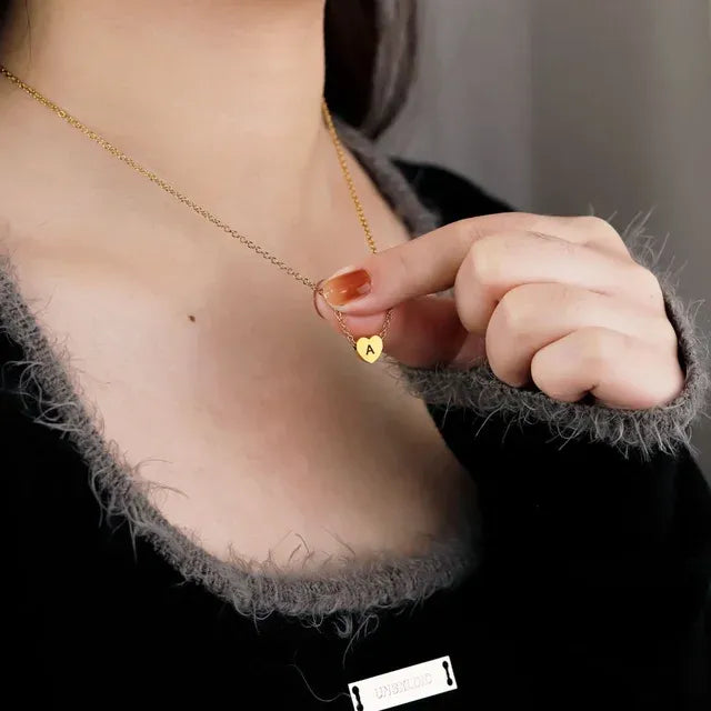Gold necklace with a heart-shaped pendant worn by a person - Affordbale artificial jewellery in pakistan