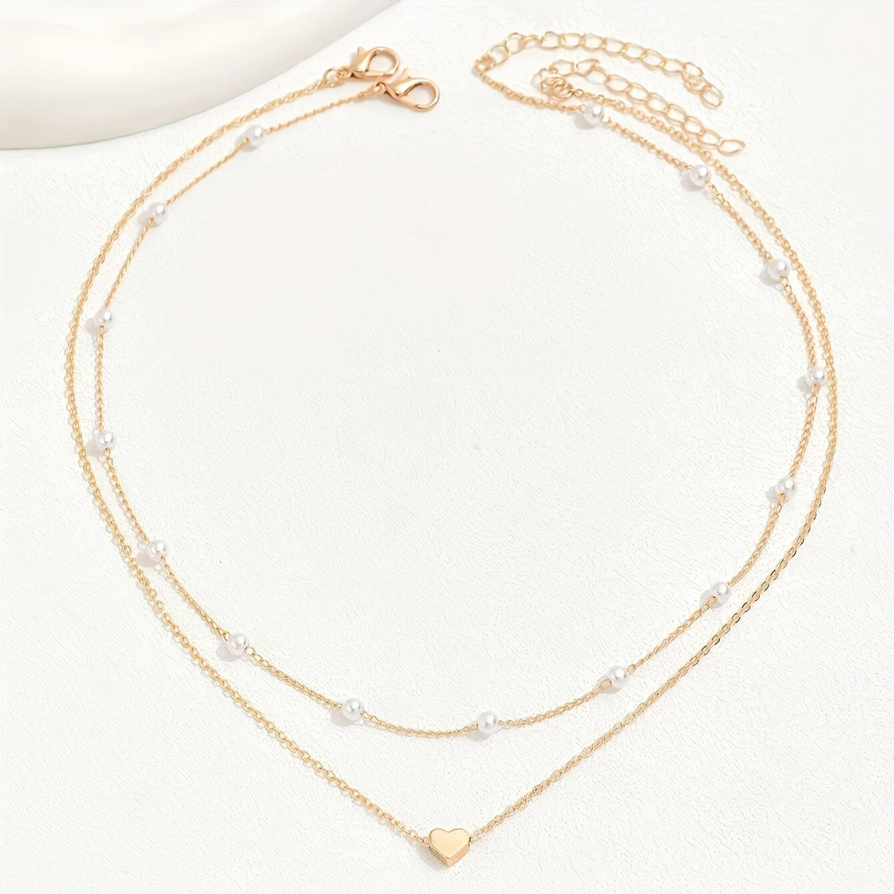 Two gold necklaces with heart pendants on a white background - Affordable Artificial jewellery in pakistan