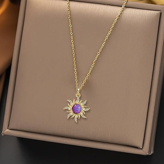 Gold necklace with a purple pendant on a beige box