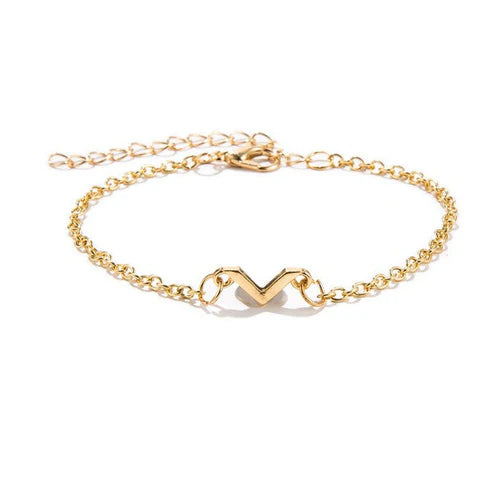 Gold bracelet with a heart-shaped clasp on a white background