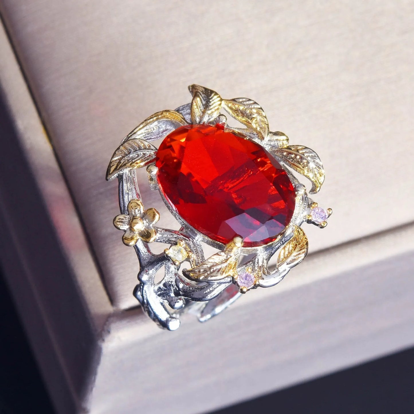 Close-up of ruby gemstone ring with vintage silver branch detailing