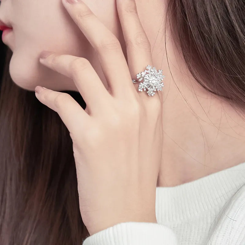 Close-up of an elegant snowflake spinning ring with intricate snowflake design, shimmering accents, and a frosty winter-inspired aesthetic.