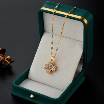 Gold necklace with a floral pendant in a green jewelry box on a dark background