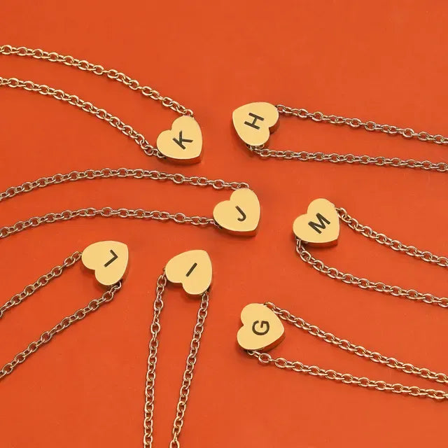 Gold necklaces with heart-shaped pendants on an orange background - Affordbale artificial jewellery in pakistan