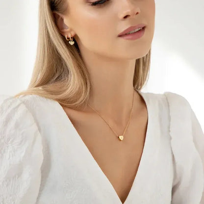 Woman wearing a gold necklace and earrings on a white background - Affordbale artificial jewellery in pakistan