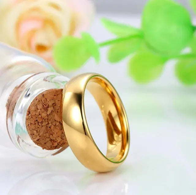 Gold ring inside a glass bottle with a cork stopper, against a blurred floral background - Affordable artifiial jewellery in pakistan