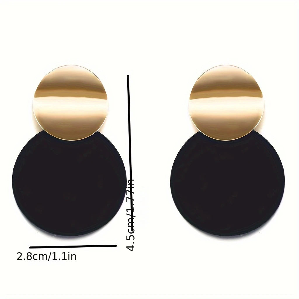 Gold and black earrings with measurements on a white background