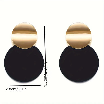 Gold and black earrings with measurements on a white background