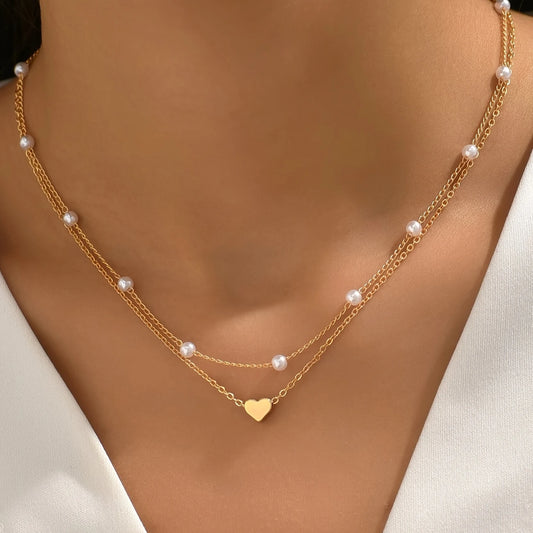 Gold necklace with heart pendant and pearl beads on a mannequin - Affordable Artificial jewellery in pakistan