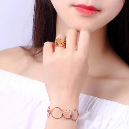 Woman wearing a 2 in 1 rose gold ring and bracelet on a white background
