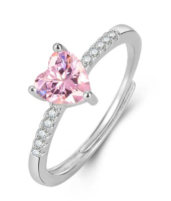 Silver ring with a pink heart-shaped gemstone on a white background