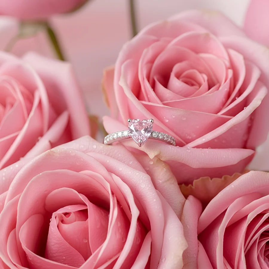 Heart-shaped diamond ring on pink roses