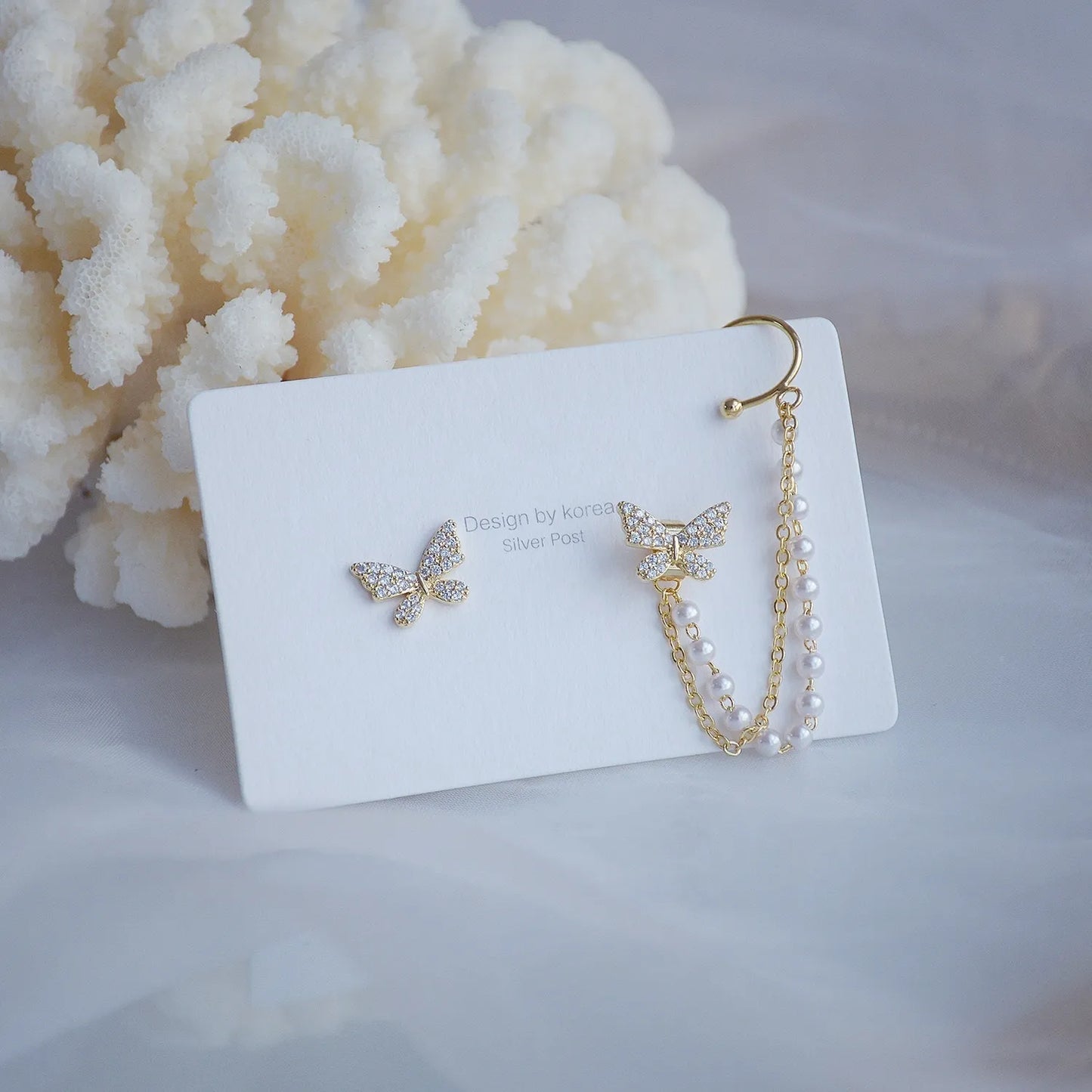 Elegant butterfly clip ear cuff with zircon and pearl details, gold-plated finish — from the best jewelry store online in Pakistan.