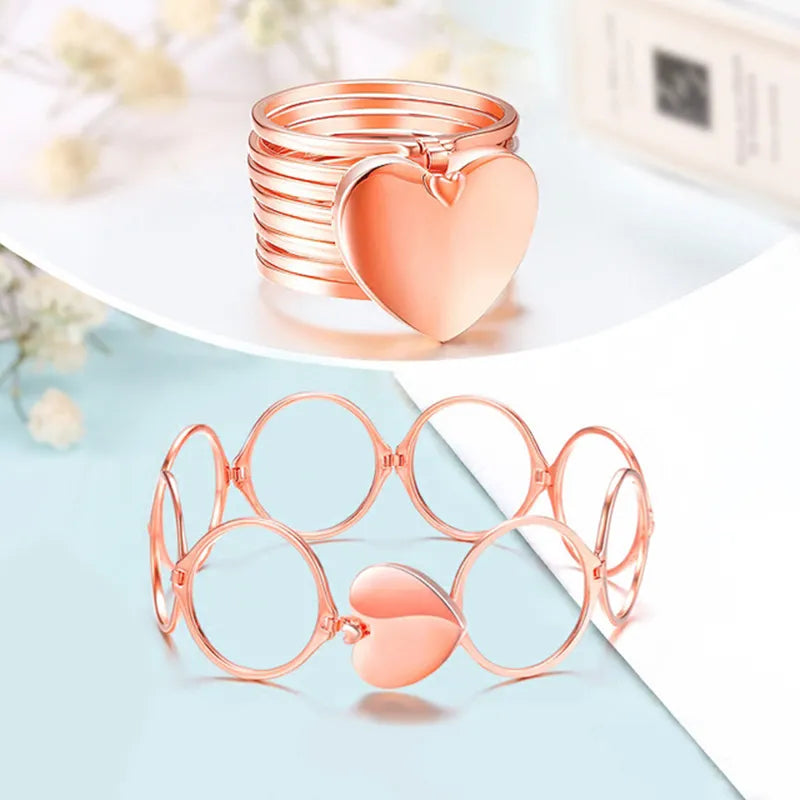 Rose gold heart-shaped jewelry 2 in 1 ring a light blue surface with a blurred background