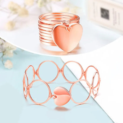Rose gold heart-shaped jewelry 2 in 1 ring a light blue surface with a blurred background