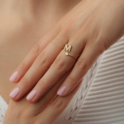 Radiant Initial Rings in elegant gold and silver, featuring a stylish adjustable design for a personalized touch.