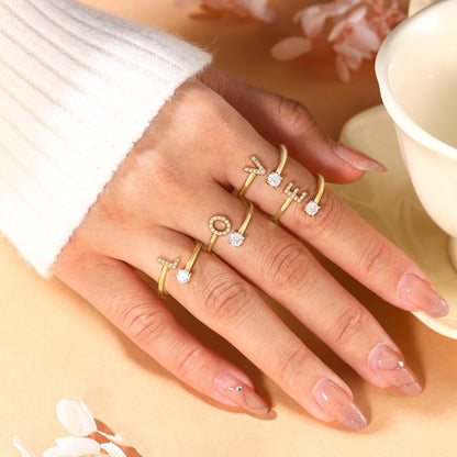 Radiant Initial Rings in elegant gold and silver, featuring a stylish adjustable design for a personalized touch.