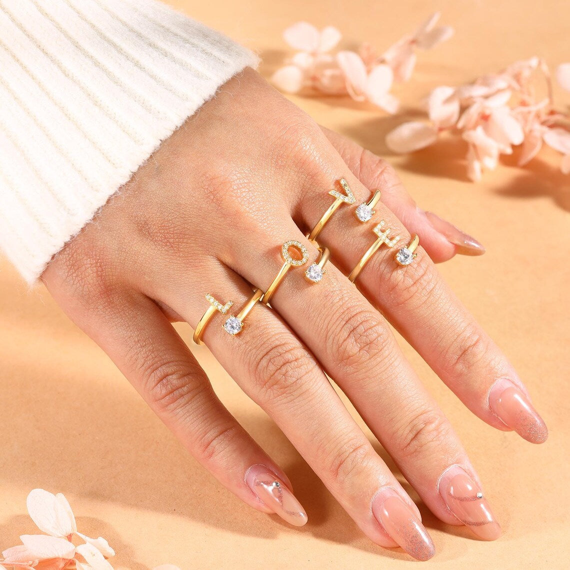 Radiant Initial Rings in elegant gold and silver, featuring a stylish adjustable design for a personalized touch.