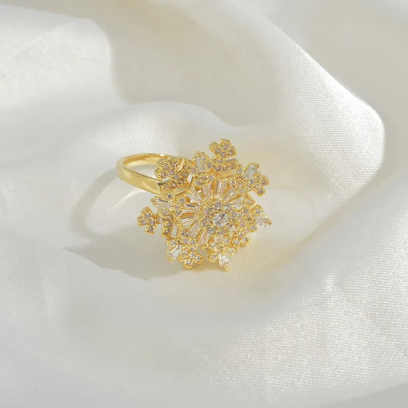 Close-up of an elegant snowflake spinning ring with intricate snowflake design, shimmering accents, and a frosty winter-inspired aesthetic.
