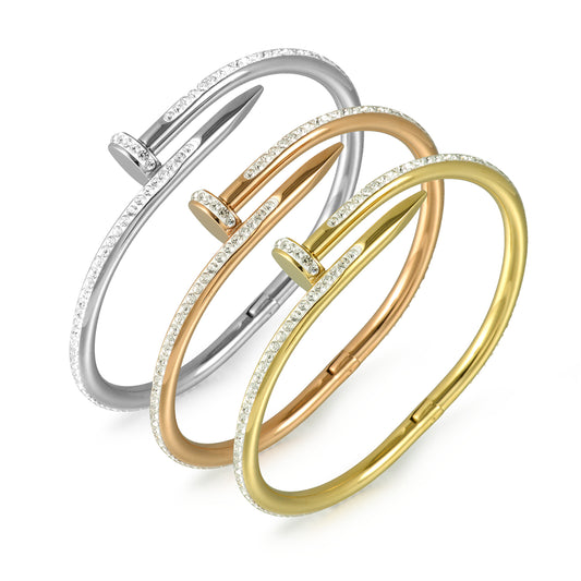 Three gold and silver bangles on a white background