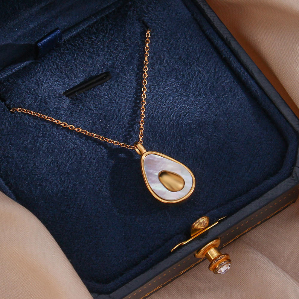 Gold necklace with a pendant in an open jewelry box