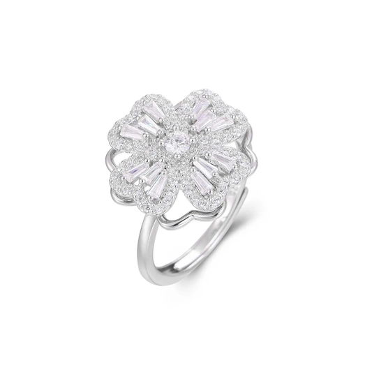 Silver ring with floral design and clear gemstones on a white background