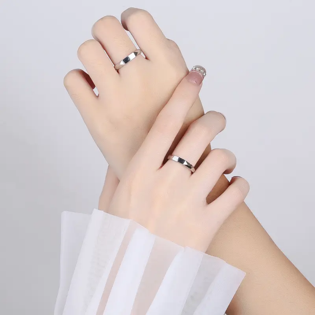 Hands wearing couple rings Pakistan silver matching rings for lovers