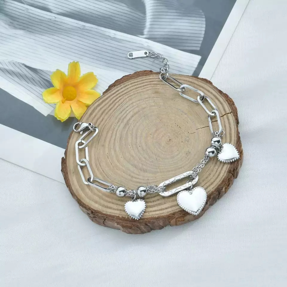 Elegant charm bracelet Pakistan stainless steel gift for women at wooden piece
